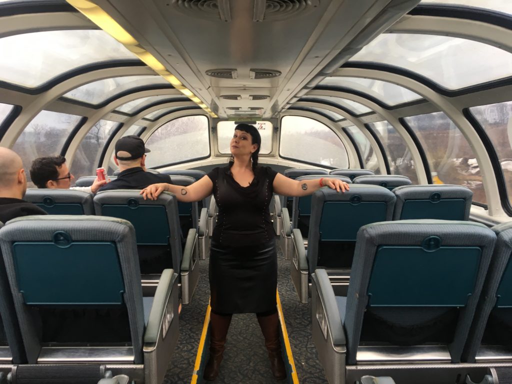 Liisa poses on the dome car of a Via Rail train