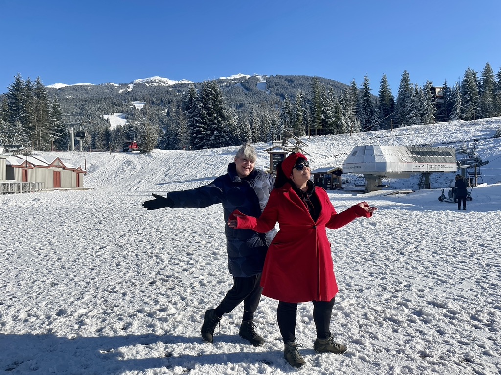 Two friends on the empty ski slopes in Whistler BC
